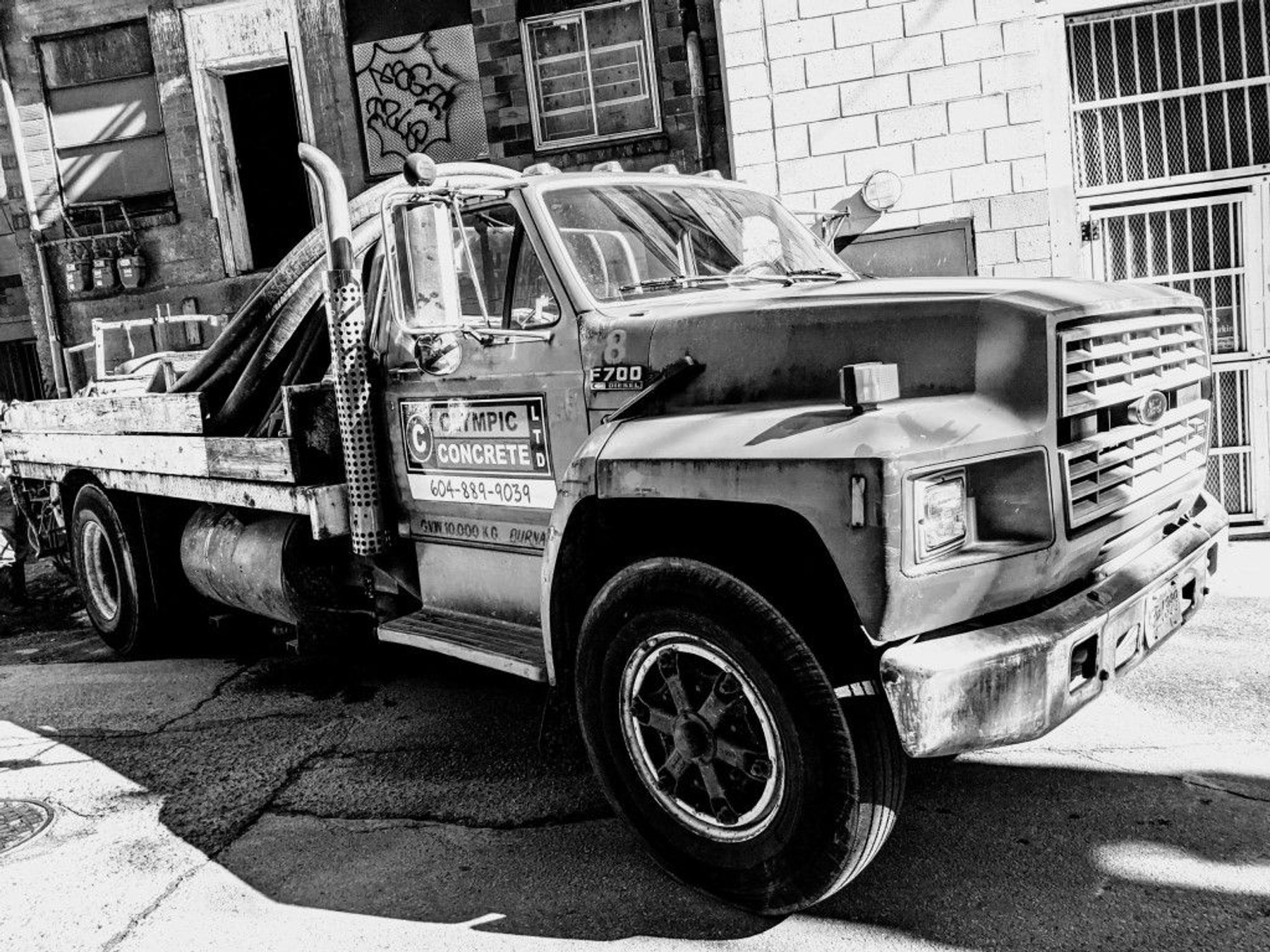 Olympic Concrete Ltd. flatbed truck, black and white