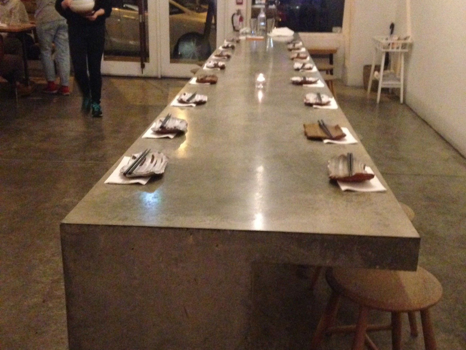 Custom concrete communal dining table at a restaurant