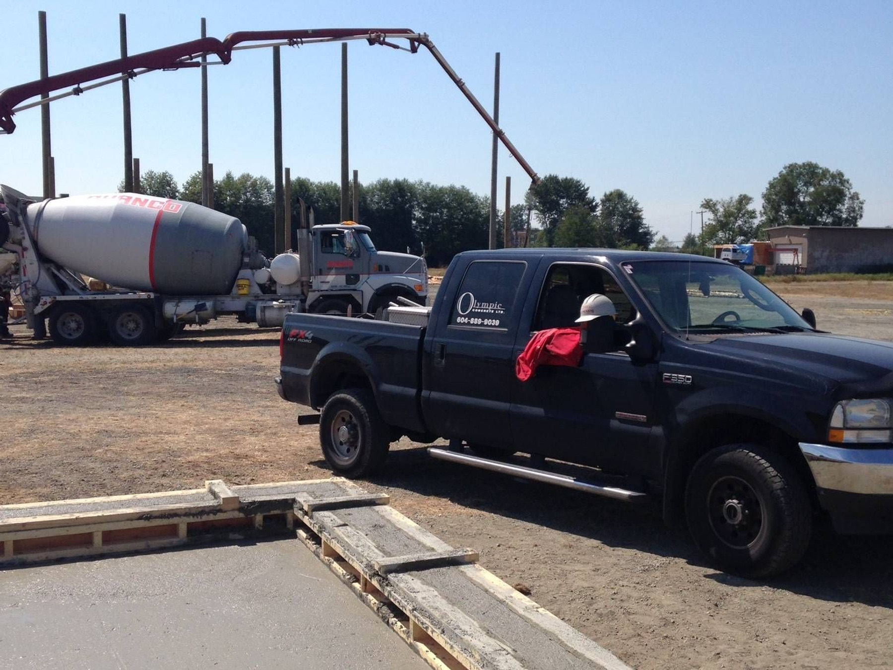 Concrete pump truck and mixer truck on a job site
